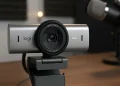 Logitech Brio 4K webcam on a desk with a podcast microphone.