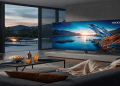 Samsung S90D OLED TV displayed in a modern living room setting showing vibrant picture quality.