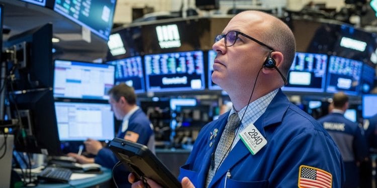 A stock trader shows concern while watching market data decline on electronic screens, illustrating the financial impact of tariffs.
