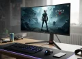 An Alienware curved gaming monitor on a desk displaying the game The Witcher 3 Wild Hunt.