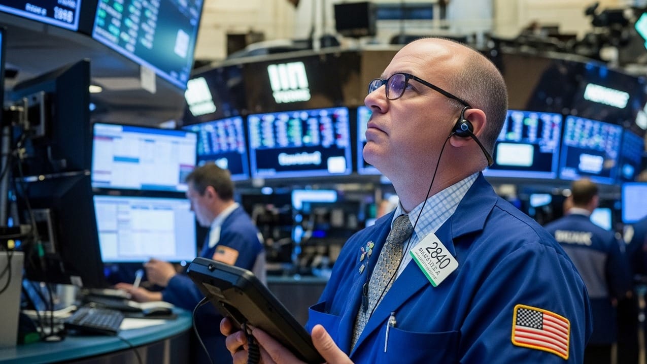 A stock trader shows concern while watching market data decline on electronic screens, illustrating the financial impact of tariffs.