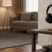 Black Sony wireless headphones on a minimalist stand atop a wooden side table in a warm living room.